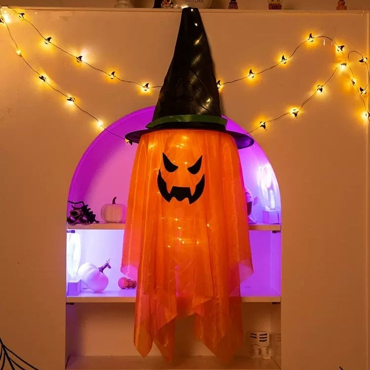 Orange jack-o-lantern hanging decoration with a black witch hat and lights.