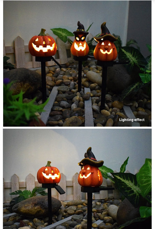 Pumpkin solar stake designs illuminated in a garden; each stake is sold individually.