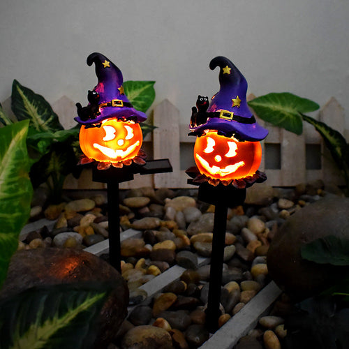 Wizard Pumpkin solar lights illuminated in a garden display; each stake is sold individually.