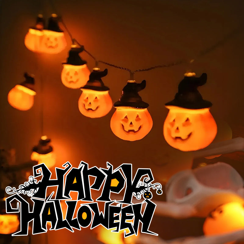 Glowing orange pumpkin string lights with black witch hats.